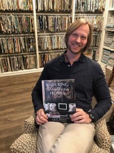 Eric Ross holding his book, Enduring Southern Homes, for interior design in Nashville call Eric Ross Interiors today!